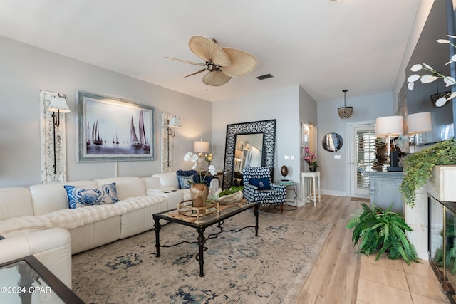 living room featuring ceiling fan and light wood-type flooring