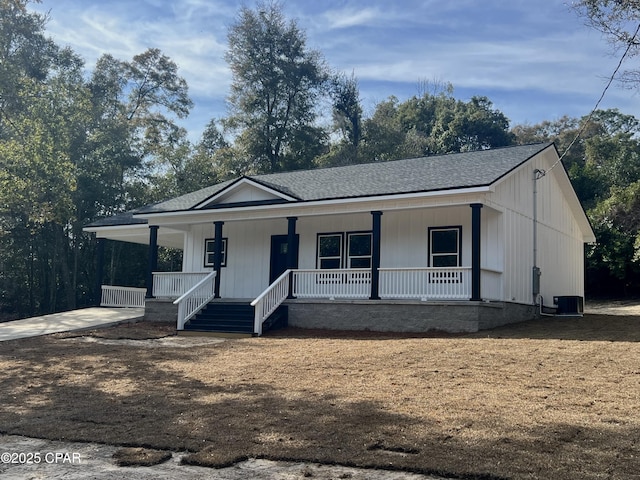 view of front of home with a porch and central AC unit