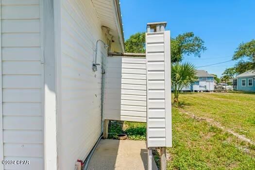 208 3rd St Unit 1/2, Panama City Beach, FL 32413 - view of side of property with a lawn and a chimney