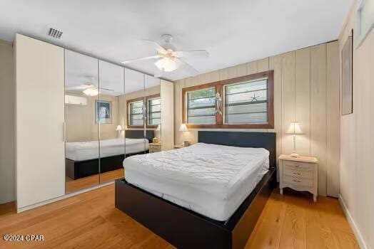 208 3rd St Unit 1/2, Panama City Beach, FL 32413 - bedroom featuring light wood-style flooring and a closet