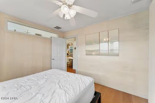 208 3rd St Unit 1/2, Panama City Beach, FL 32413 - bedroom featuring wood finished floors and ceiling fan