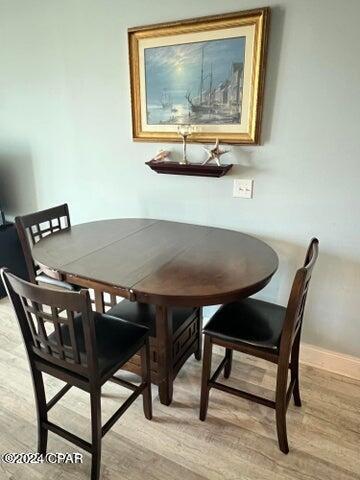 dining room with light wood-style flooring and baseboards