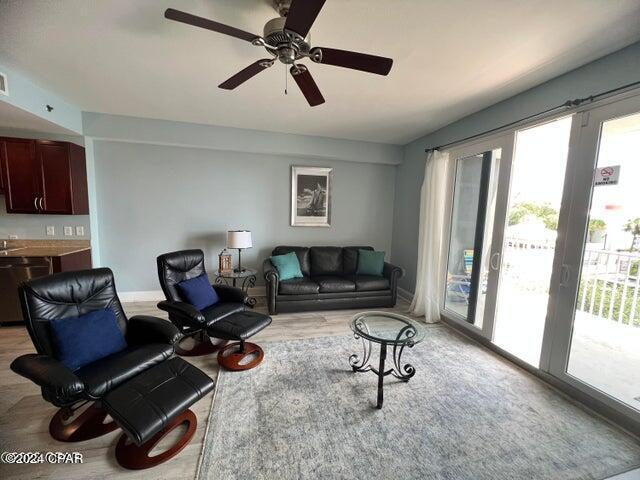 living room featuring ceiling fan and baseboards