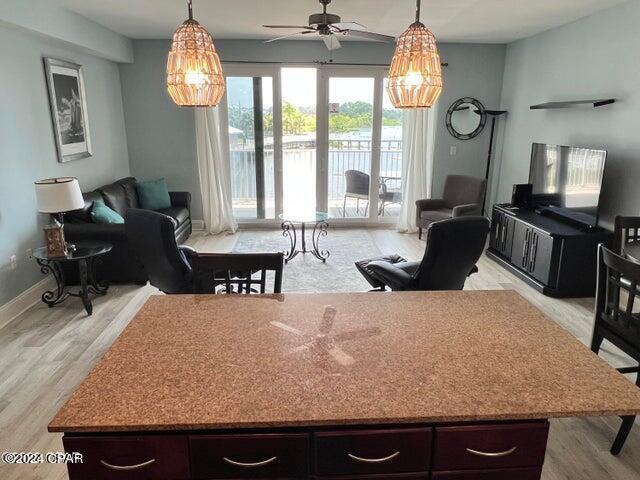 kitchen featuring dark brown cabinetry, light wood finished floors, and open floor plan