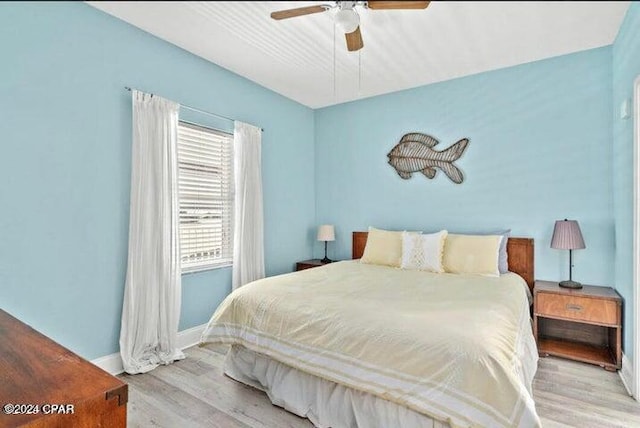 bedroom featuring wood finished floors, a ceiling fan, and baseboards