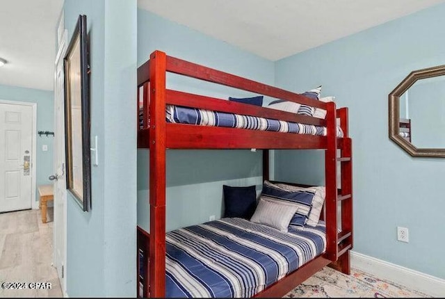 bedroom with baseboards and wood finished floors