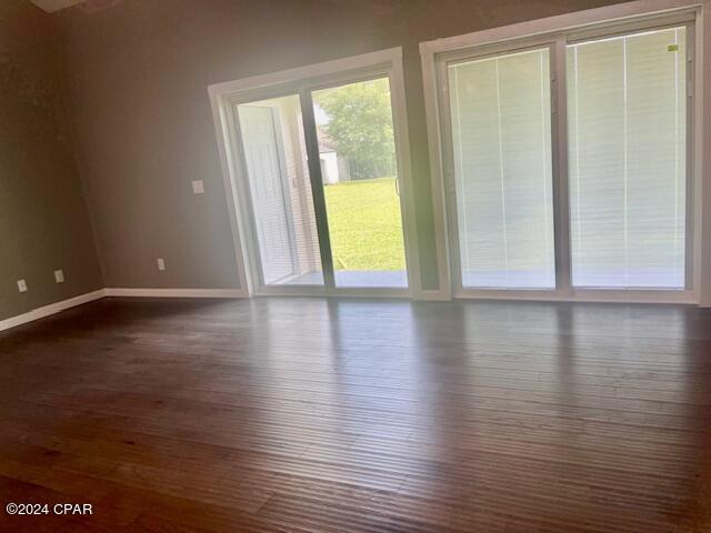 spare room featuring dark hardwood / wood-style floors