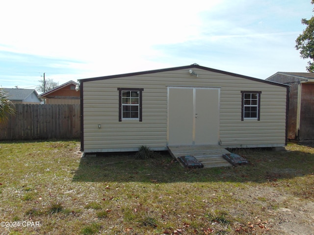 view of outbuilding with a lawn