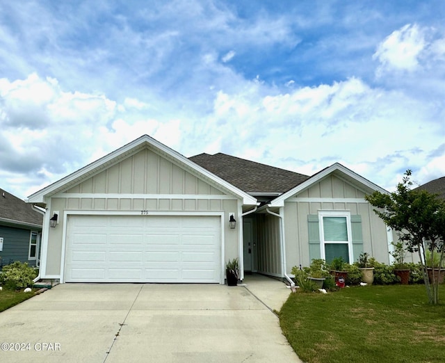 view of front of house featuring a front yard and a garage