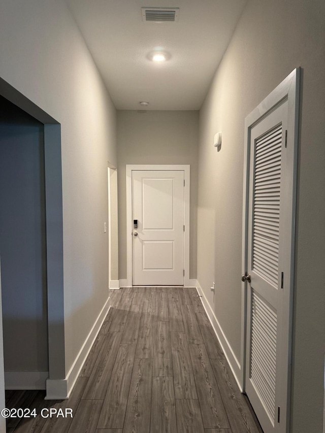 corridor featuring dark hardwood / wood-style floors