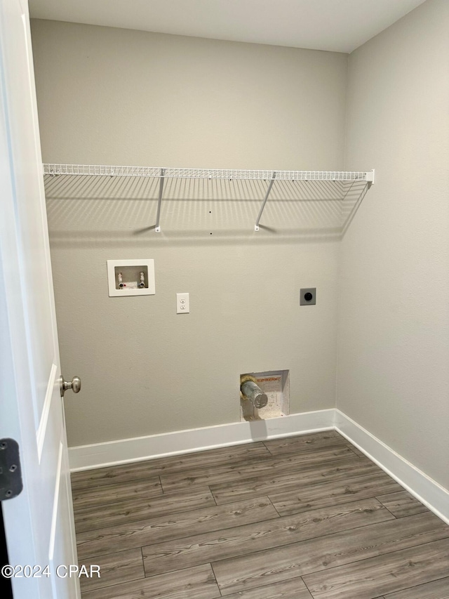 clothes washing area with hookup for a washing machine, dark hardwood / wood-style floors, and electric dryer hookup