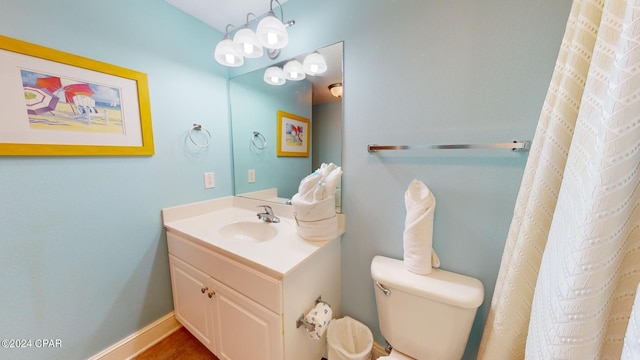 bathroom with toilet and large vanity