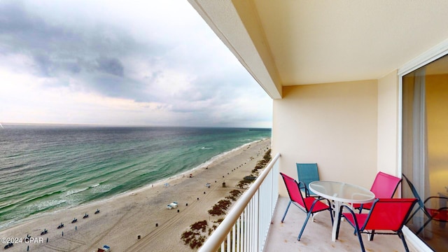 balcony with a beach view and a water view