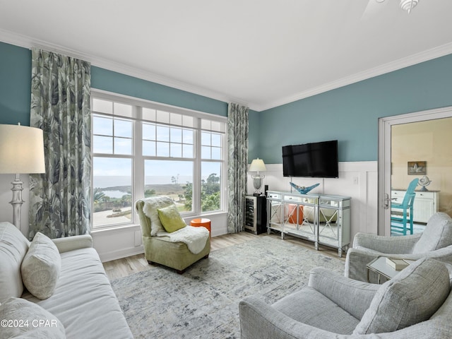 living room with hardwood / wood-style flooring and crown molding