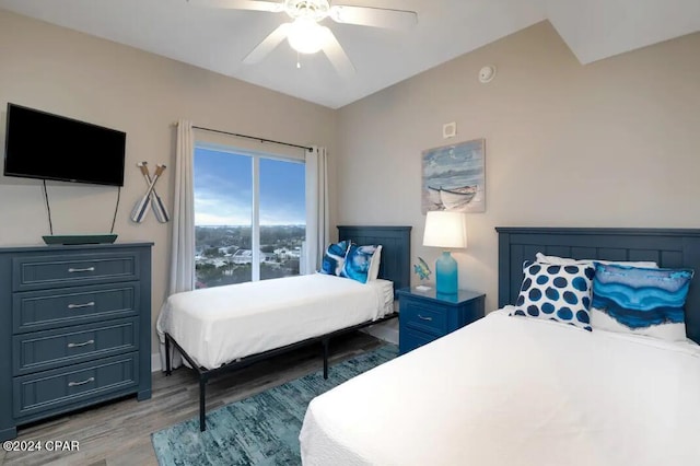 bedroom with ceiling fan and dark hardwood / wood-style flooring