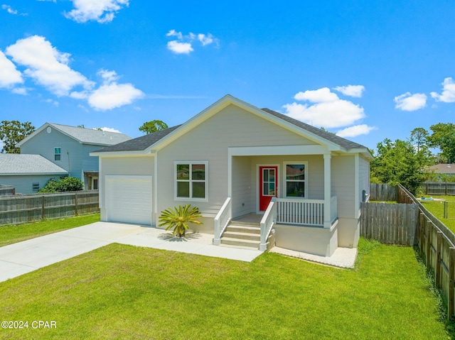 view of front facade with covered porch, a garage, and a front yard