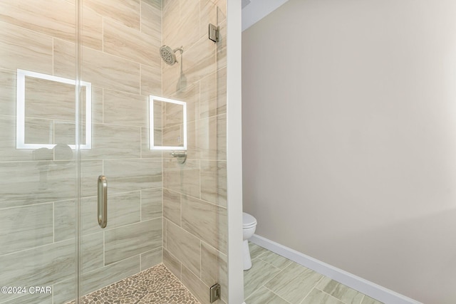 bathroom with walk in shower, tile patterned floors, and toilet