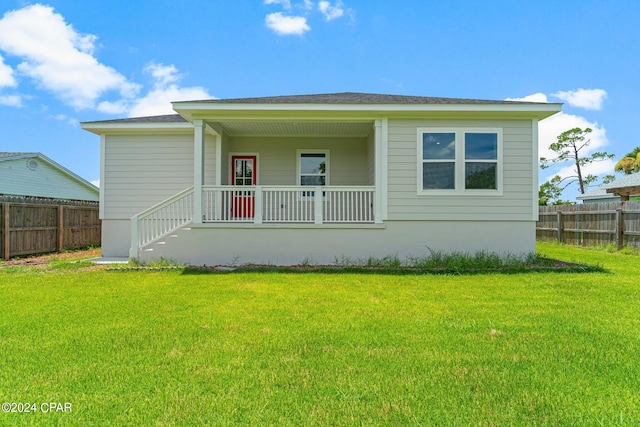 view of front of property with a front yard and covered porch