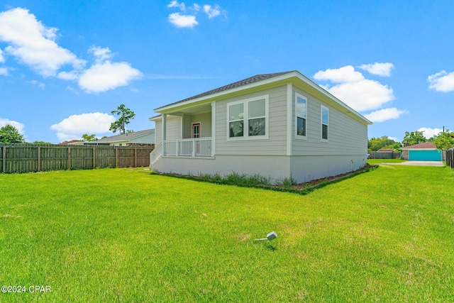 view of side of home with a yard