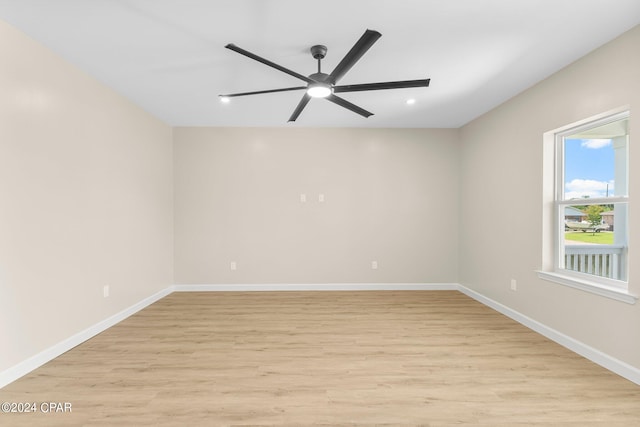 spare room featuring light wood-type flooring and ceiling fan