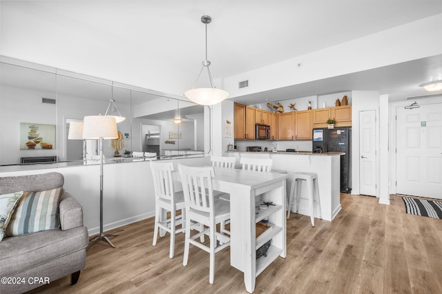 dining room with light wood-type flooring