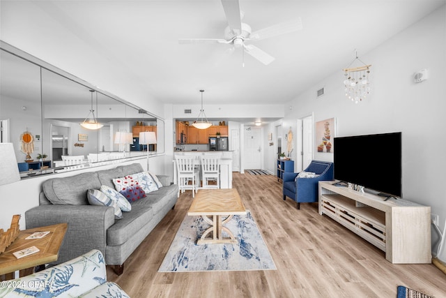 living room featuring ceiling fan and light hardwood / wood-style flooring