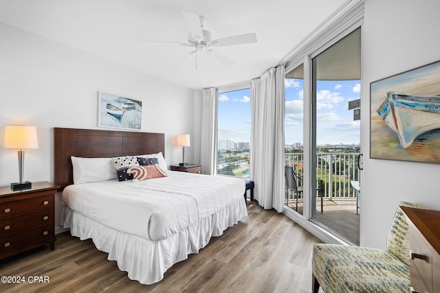 bedroom with wood-type flooring, ceiling fan, and access to outside