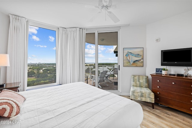 bedroom featuring ceiling fan, multiple windows, light hardwood / wood-style floors, and access to outside