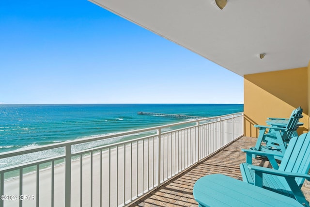 balcony featuring a water view and a view of the beach