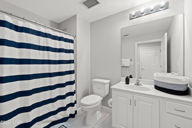 bathroom featuring toilet, a shower with curtain, a textured ceiling, vanity, and tile patterned flooring