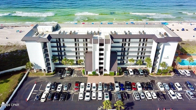 drone / aerial view featuring a beach view and a water view