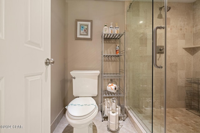 bathroom with a shower with shower door, tile patterned floors, and toilet