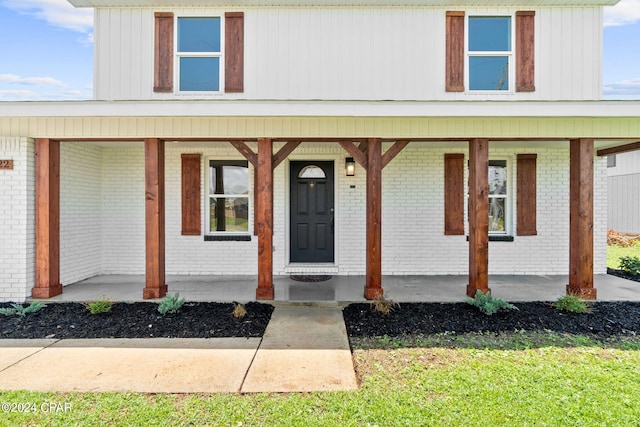 doorway to property featuring covered porch