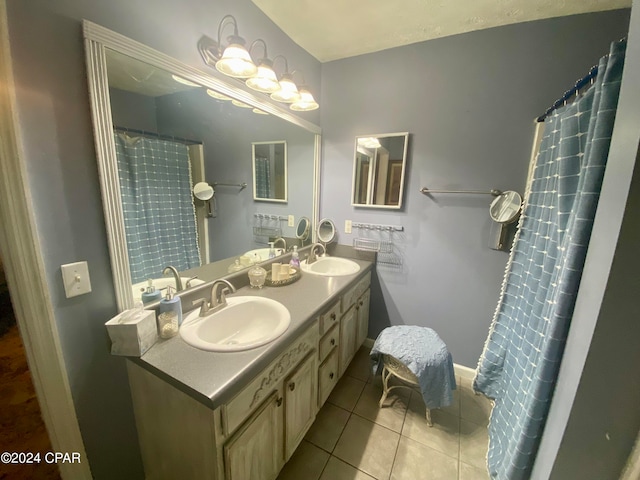 bathroom with dual vanity and tile patterned flooring