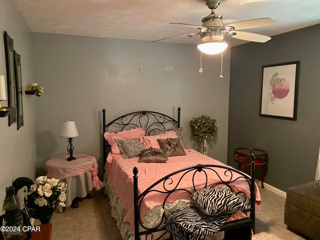 bedroom with ceiling fan and light tile patterned floors