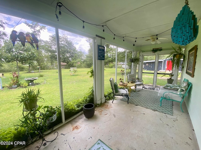 unfurnished sunroom with ceiling fan