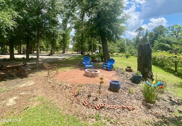 view of home's community featuring an outdoor fire pit