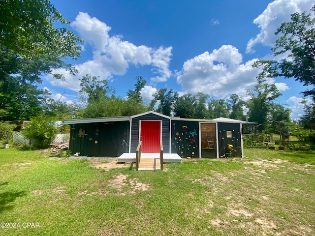 view of outbuilding with a yard