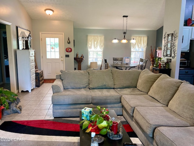 tiled living room featuring a chandelier