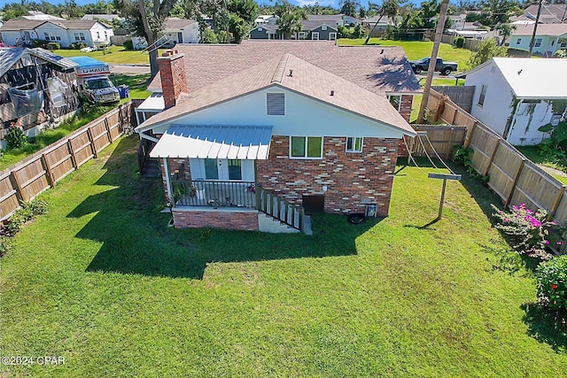 rear view of property featuring a yard