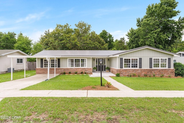 ranch-style home with cooling unit and a front yard