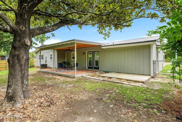 rear view of property with ceiling fan and a patio