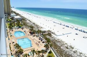 bird's eye view with a water view and a view of the beach