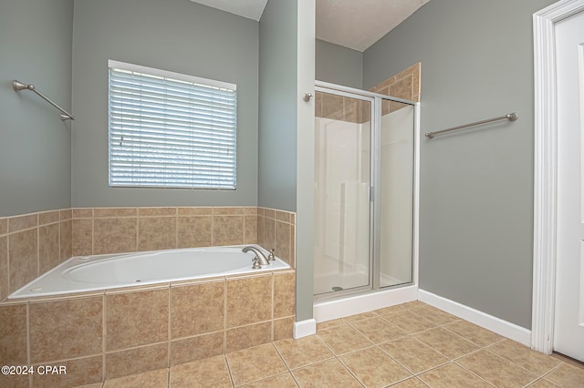 bathroom with a textured ceiling, tile patterned floors, and shower with separate bathtub