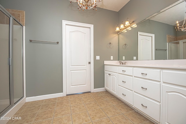 bathroom with vanity, a chandelier, an enclosed shower, and tile patterned flooring