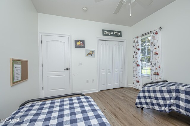 bedroom featuring ceiling fan, a closet, and light hardwood / wood-style floors