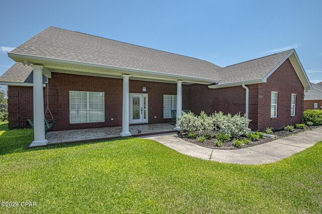 single story home with a front lawn and french doors