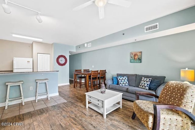 living room with ceiling fan, hardwood / wood-style flooring, and track lighting