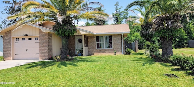 ranch-style home with a front yard, an attached garage, brick siding, and concrete driveway