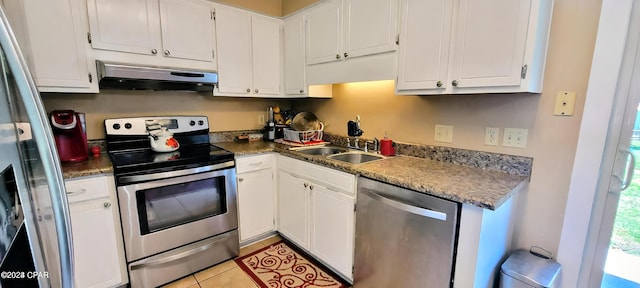 kitchen featuring sink, white cabinets, light tile flooring, and stainless steel appliances